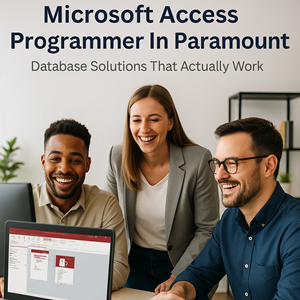 Happy business professionals in business casual reviewing a Microsoft Access database on a computer screen